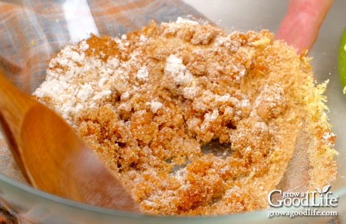 Mixing the sugars, flour, lemon zest, cinnamon, and nutmeg in a large bowl.