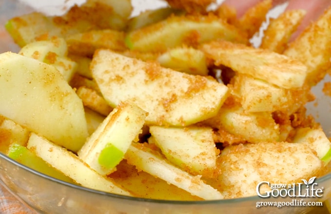 Close up view of tossing the apple slices to coat them with the spice mixture.