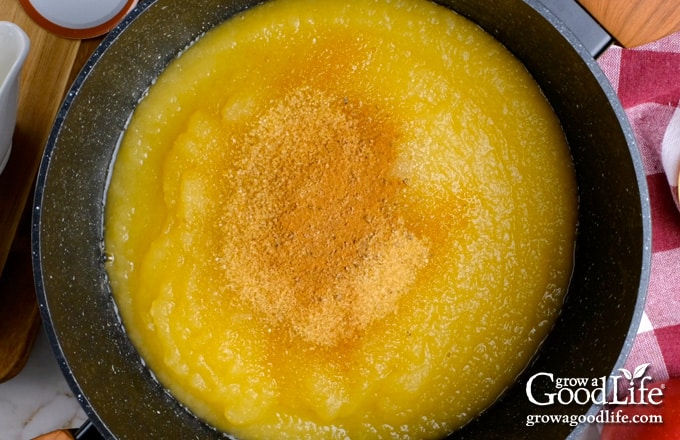 Adding sugar and spices to the applesauce.