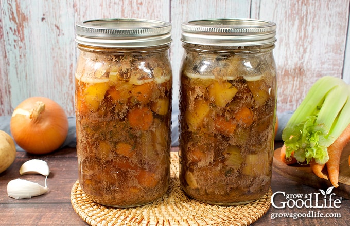 Two jars of home canned beef pot roast on a table.