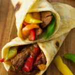 These sizzling beef steak fajitas are made with strips of steak infused with a flavorful chili-lime marinade, combined with colorful peppers, onions, and folded into a warm tortilla.