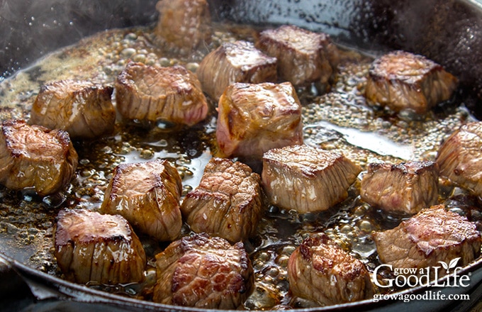 close up of beef cooking in a skillet