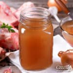 A jar of beef stock on a table.