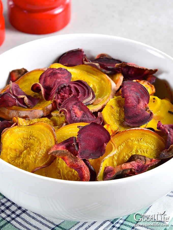 gold and red beet chips in a white bowl