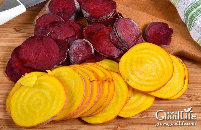 sliced gold and red beets on a cutting board