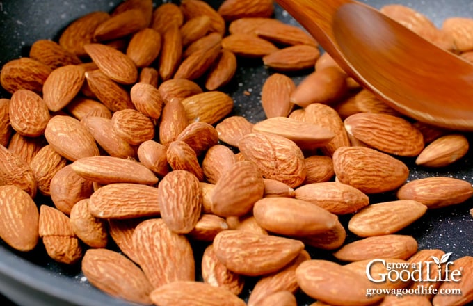 Toasting the almonds in a skillet.