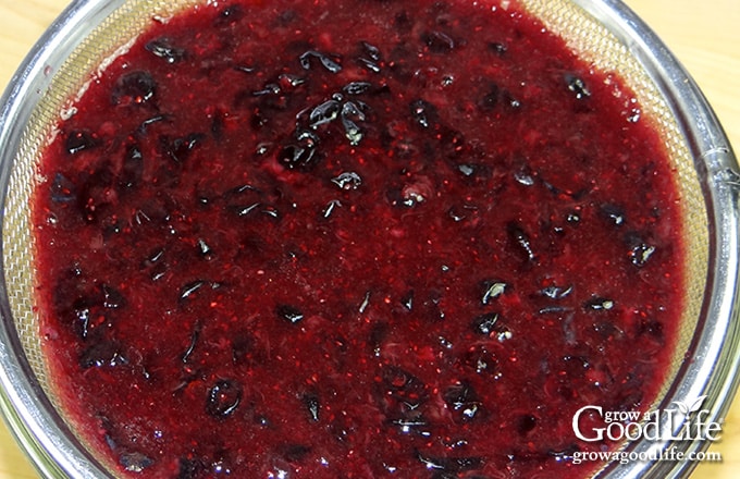 Close up of cooked blueberries in a strainer.