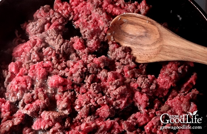 Add your ground beef to the skillet and cook it until brown. Drain the fat and add the cooked beef to your slow cooker crock.