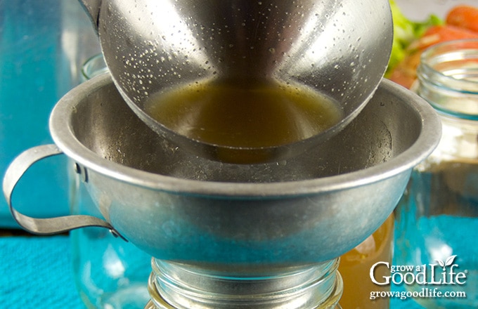 filling the jar with chicken stock