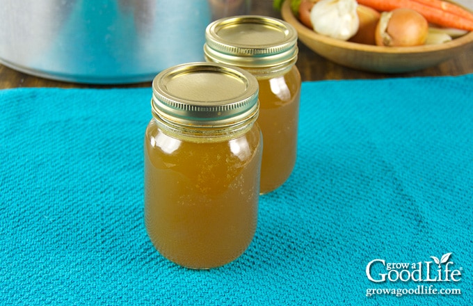 jars of home canned chicken stock on a table