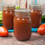 Jars of home canned barbecue sauce on a table.