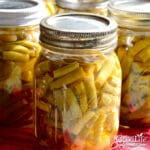 jars of home canned green beans cooling on the counter