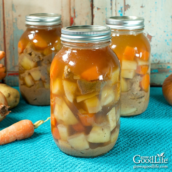 jars of home canned beef stew on a table