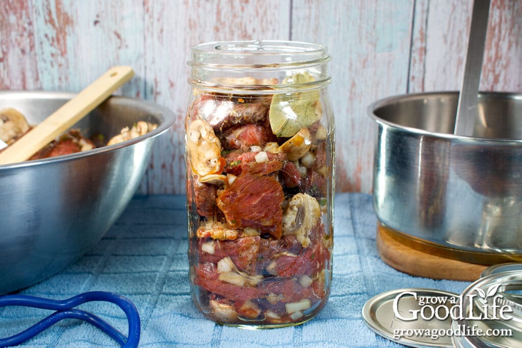 A quart jar filled with the raw beef mixture.