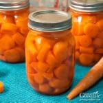 three jars of carrots on a blue towel