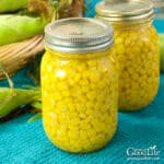 Jars of home canned corn on a table.