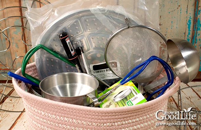 canning tools in a pink fabric gift basket