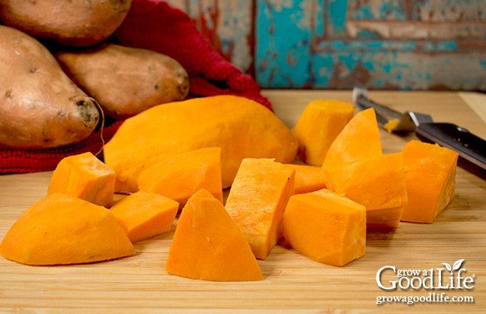 cubes of sweet potatoes on a cutting board