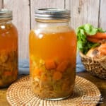 Jars of home canned turkey soup on a table.