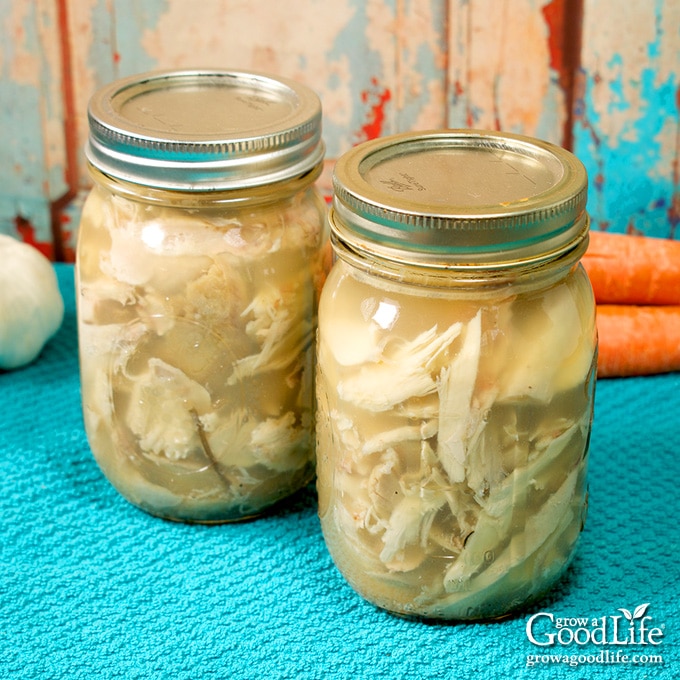 two jars of canned turkey meat on a blue towel