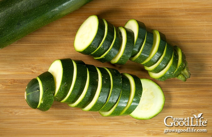 Sliced zucchini on a cutting board.