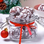 jar of chocolate crinkle cookies with christmas decorations