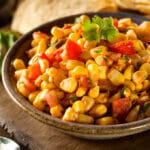 closeup of a bowl of corn salsa on a table