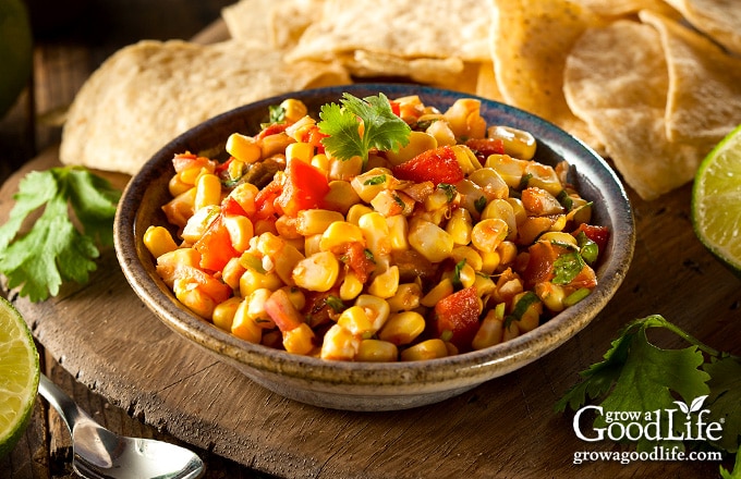 brown bowl of corn salsa on a table