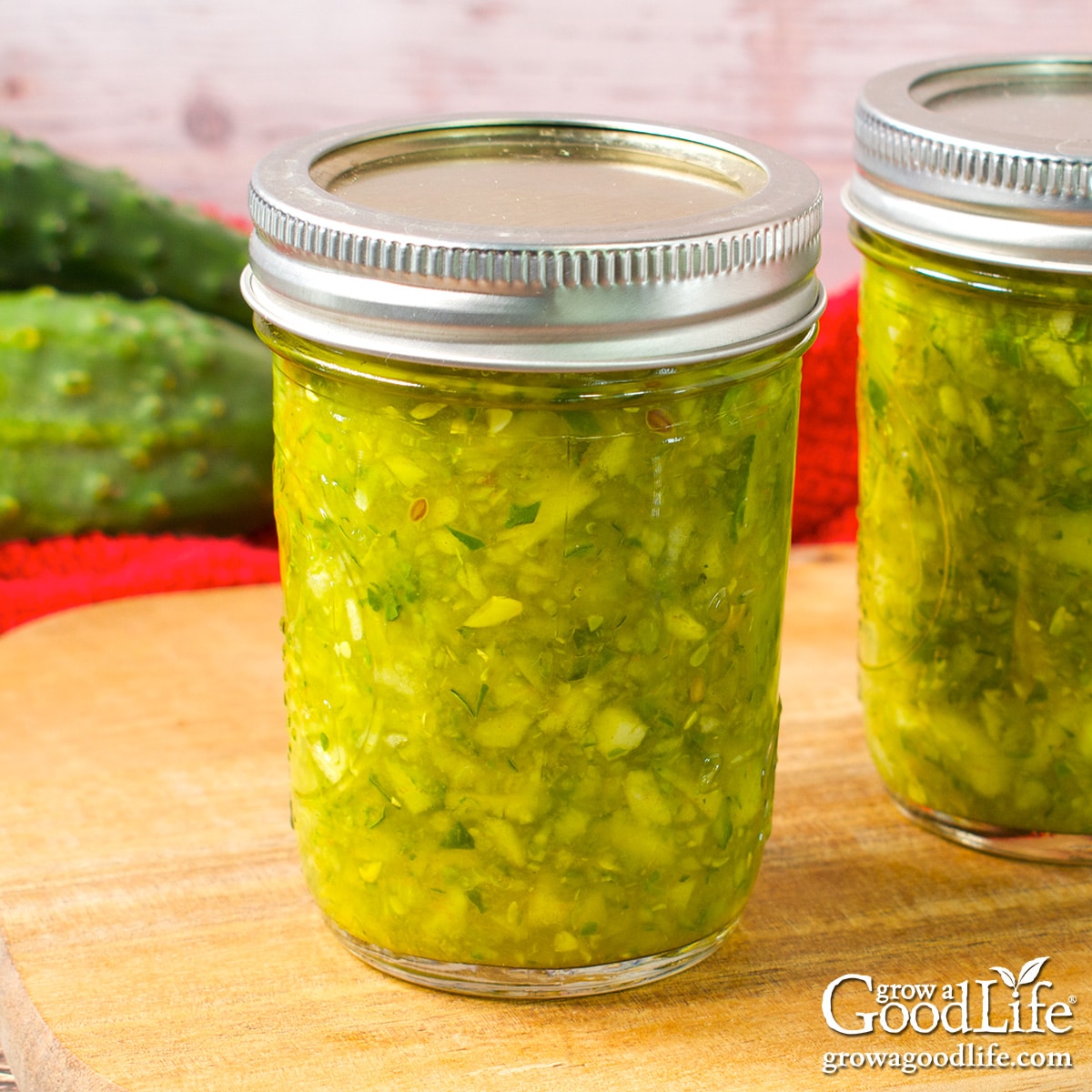 Jars of home canned dill relish on a table.