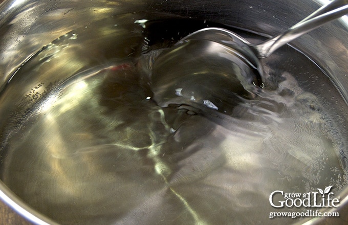 stirring pickling brine in a pot