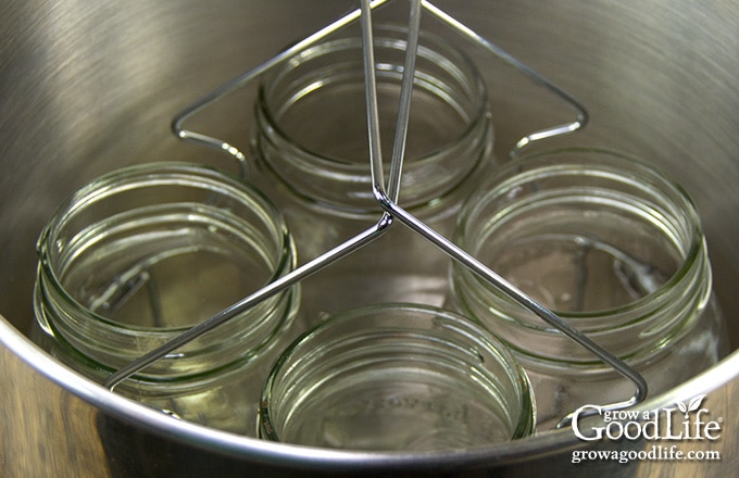 four canning jars in a large pot