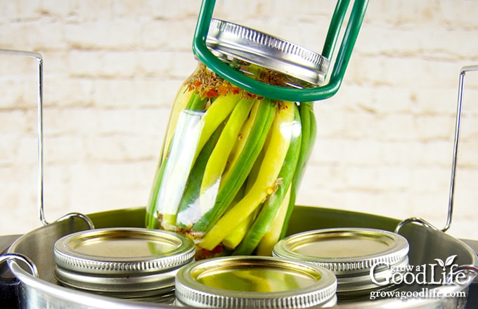 placing filled jar into a water bath canner