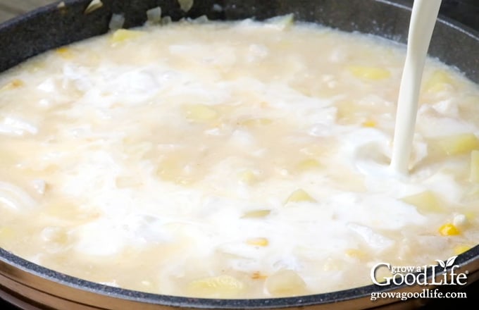 adding cream to the chowder