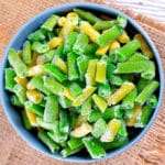 blue bowl of frozen string beans on a table