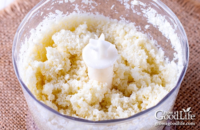 overhead of pureed garlic in a food processor