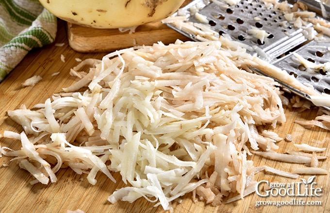 shredding potatoes with a box grater