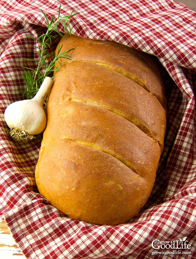 This garlic rosemary bread recipe has a whole head of roasted garlic baked into the dough. Oven roasting mellows the flavor of garlic and the soft, roasted cloves vanish into the bread dough giving you a mild garlic flavor with each and every bite.