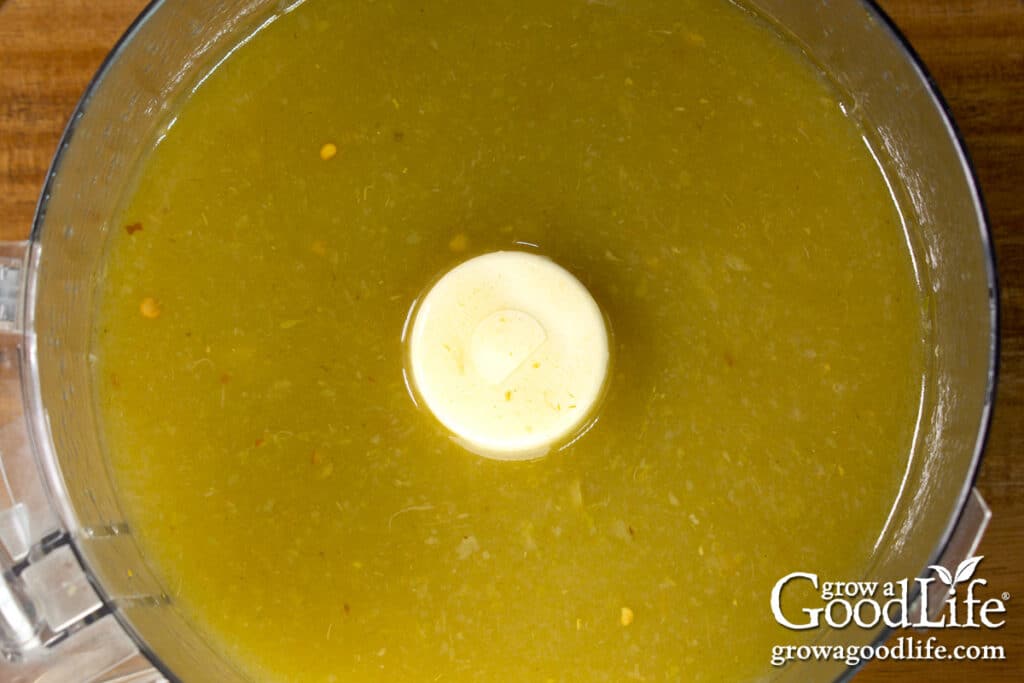 Blended green chile enchilada sauce in a food processor bowl.