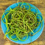 This grilled garlic scapes recipe adds a layer of sweet smoky char to the mild garlicky flavor, and then enhances it further with a simple dusting of sea salt and freshly ground pepper.