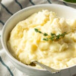 white bowl of mashed potatoes on a table