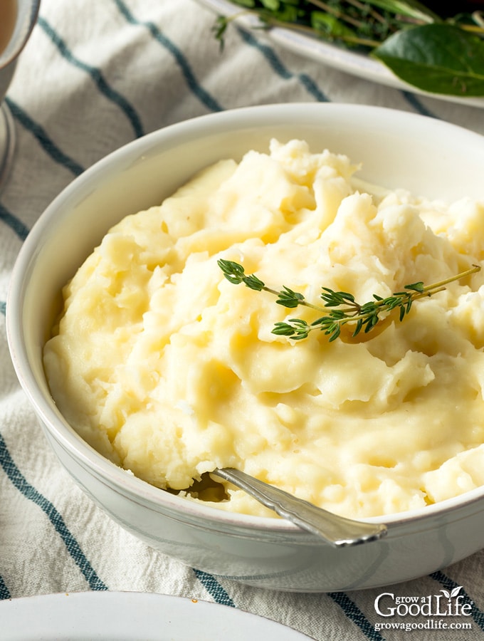 white bowl of mashed potatoes on a table