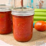 Jars of home canned stewed tomatoes on the counter.