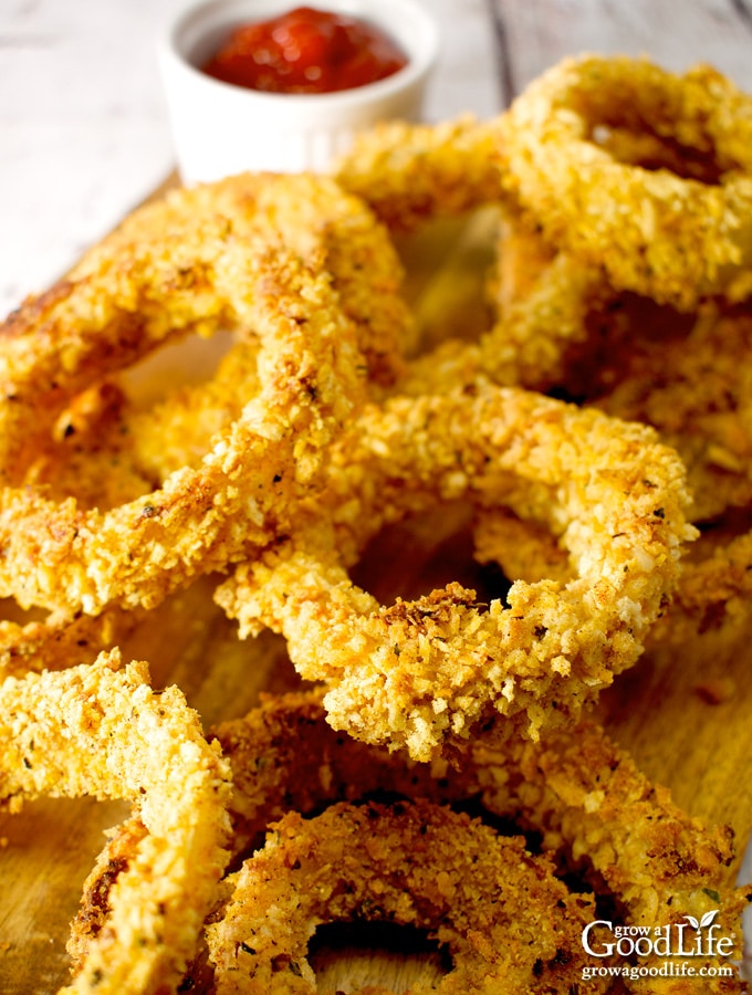 closeup photo of a pile of baked onion rings on a table