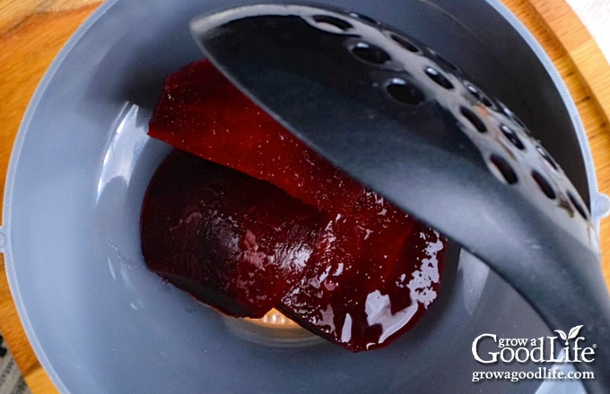 Filling the warm jar with beets.