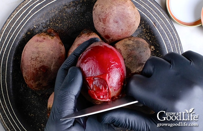 Removing the skins with a paring knife.