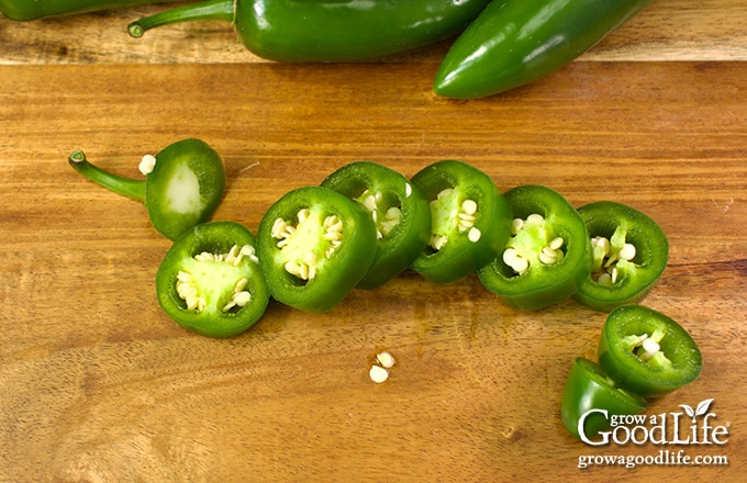 sliced jalapeños on a cutting board