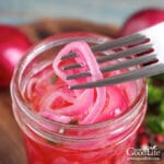 overhead image of vibrant red picked onions in a jars