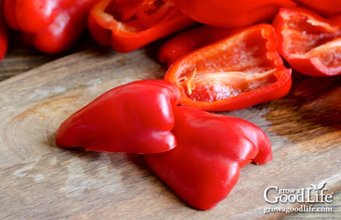 Raw bell peppers on a cutting board.