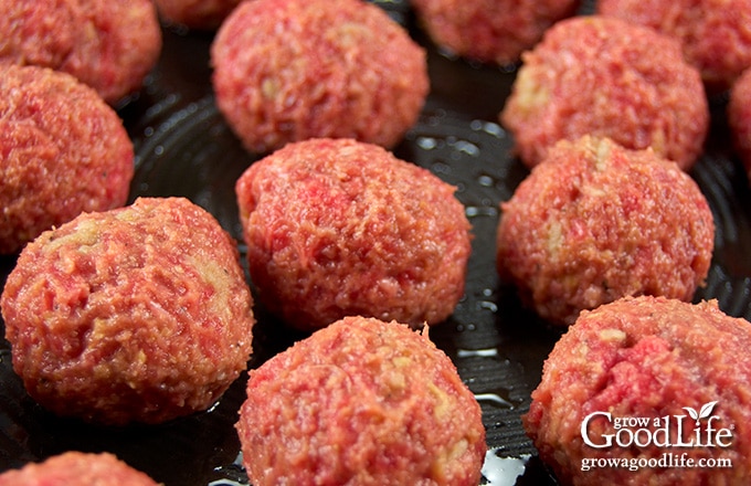 image of meatballs cooking in a skillet