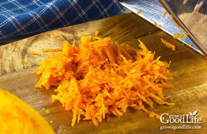 a pile of fresh orange zest on a cutting board